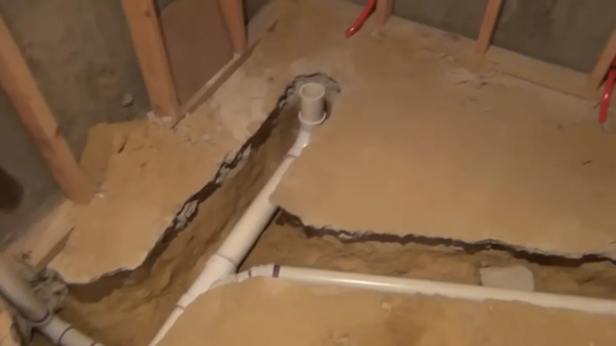 New drain pipe rough-in through a cut basement slab