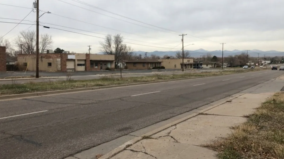 Commercial street in Federal Heights, Colorado with the Front Range in the background