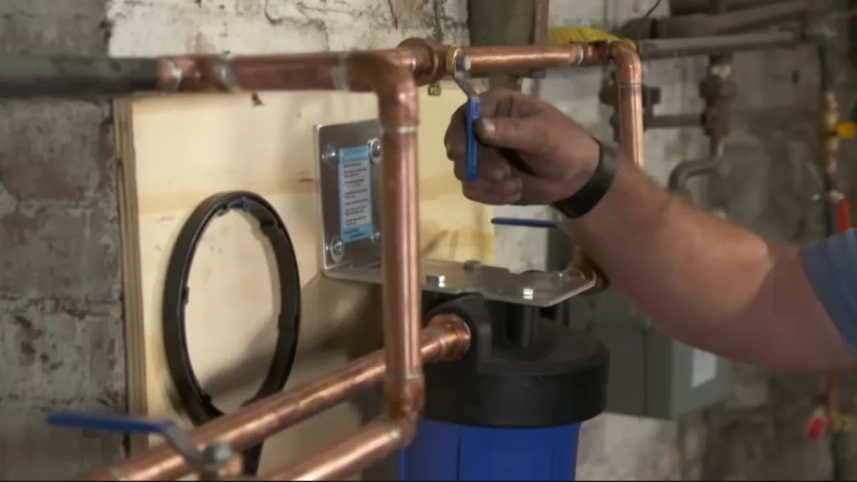 Whole-home water filtration canister connected to copper plumbing